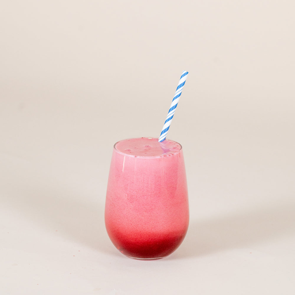 
                  
                    A bright red drink with a blue striped paper straw sits against a white backdrop. The drink was made using the FYXX Ticker Drink Mix.
                  
                