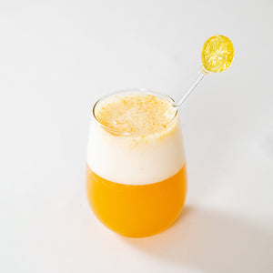 
                  
                    A bright orange drink with a glass lemon stirrer sits against a white backdrop. The drink was made using the FYXX Tummy Drink Mix.
                  
                