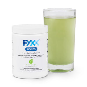 
                  
                    A jar of FYXX Bones dietary supplement powder sits next to a mixed and ready-to-drink glass. The matcha green tea with natural peach flavor can be seen in the green color of the drink.
                  
                